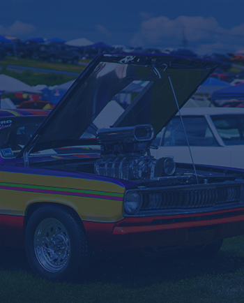 A car on the Showfield with its hood opened.